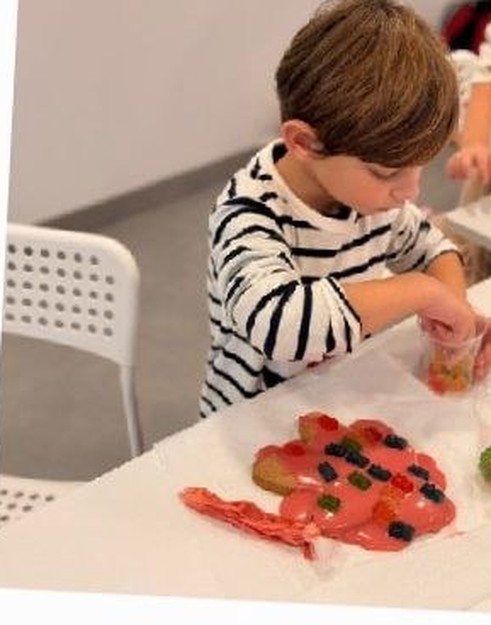 A child making a craft shape at the table